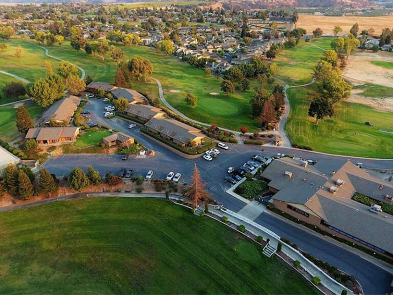 Aerial view of Ridgemark Golf Club & Resort with the clubhouse, lodging, fairways, and surrounding Hollister neighborhood.