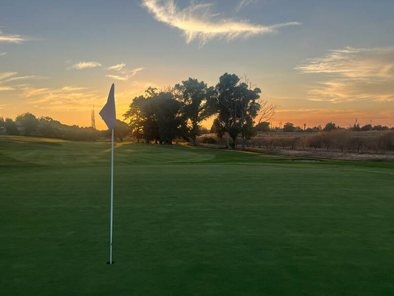 Golf green and flagstick at sunset at Ridgemark Golf Club & Resort in Hollister, California.
