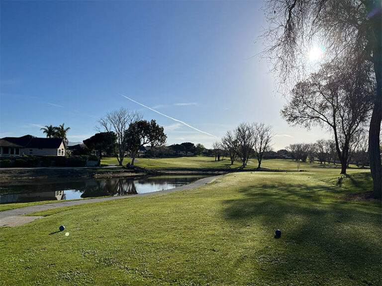 Teeing area beside a pond at Ridgemark Golf Club & Resort on a sunny day.